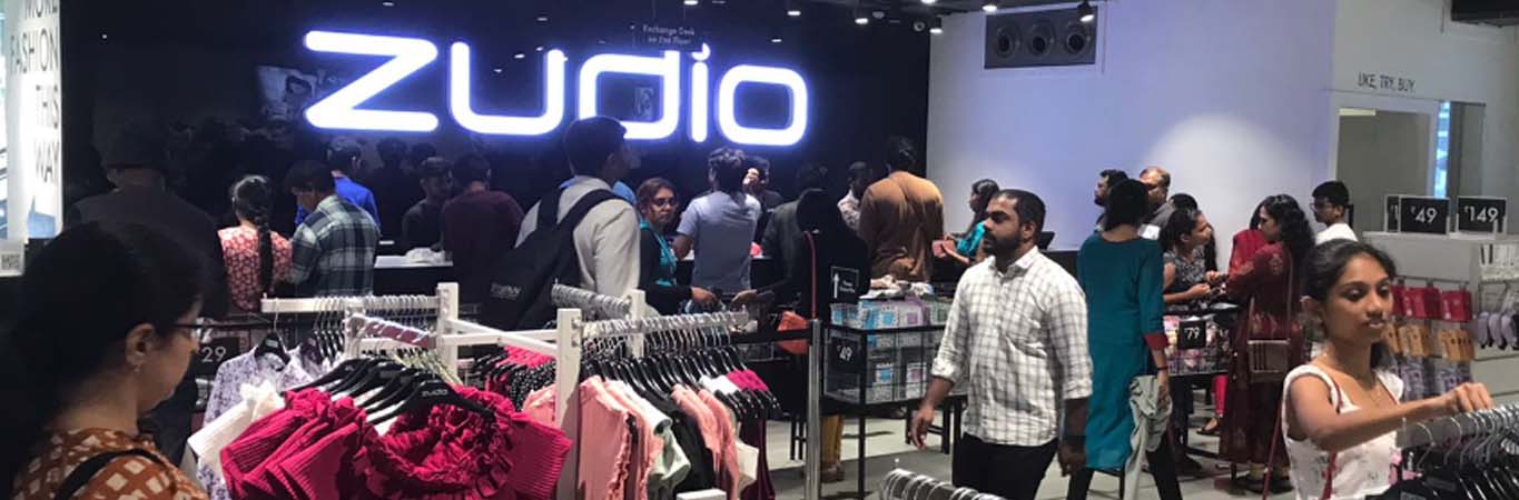 Shoppers in a clothing store with value-price displays